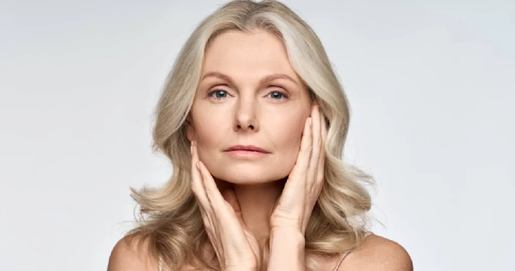 Woman with smooth skin touching her face, showing healthy aging after Viora Skin Tightening treatment in Broomfield, CO