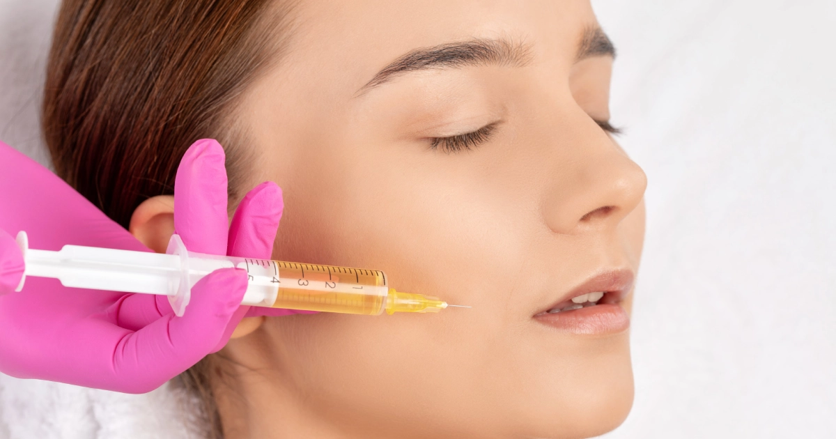 Close-up of a woman receiving PRP Facial Injections in Broomfield, CO, administered by a professional wearing pink gloves in a clinical setting.